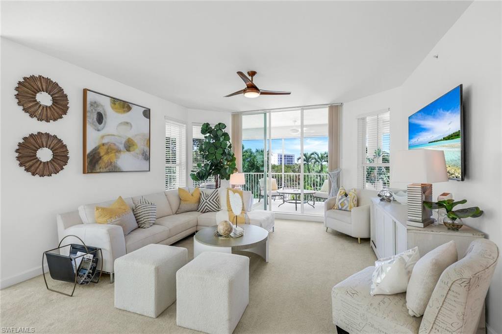 315 Dunes Boulevard, Unit 201 Naples, FL 34110 - Photo 9 of 30 a living room with furniture and a large window