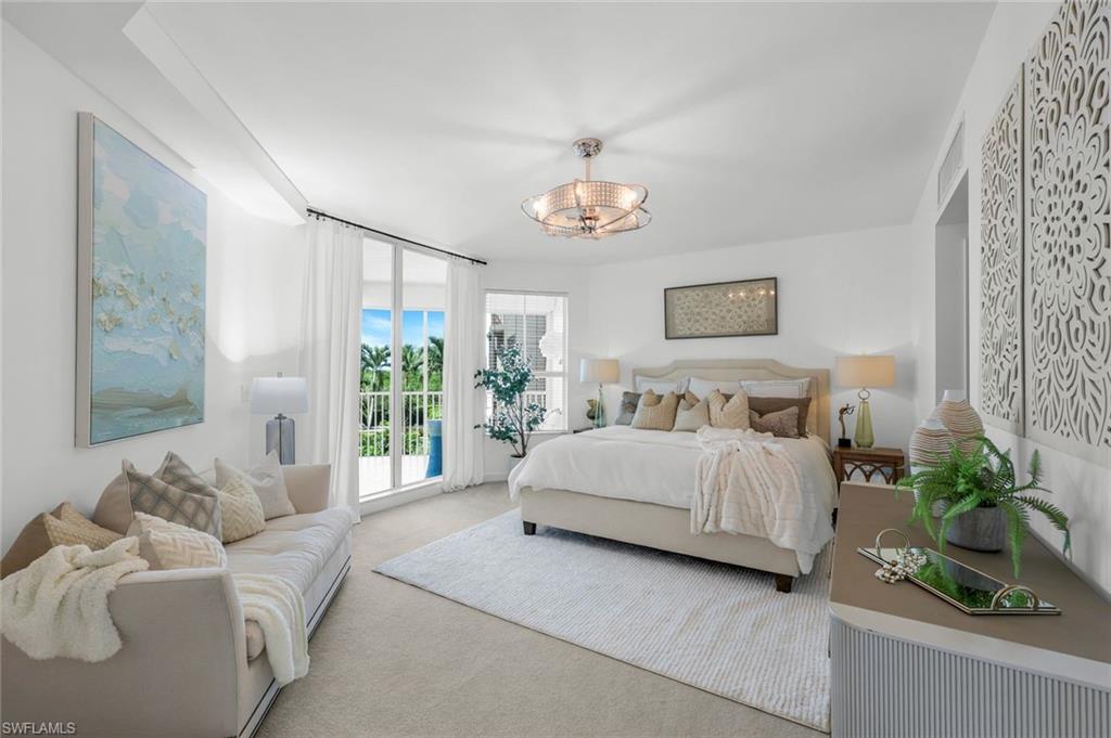 315 Dunes Boulevard, Unit 201 Naples, FL 34110 - Photo 10 of 30 a spacious bedroom with a bed and a couch