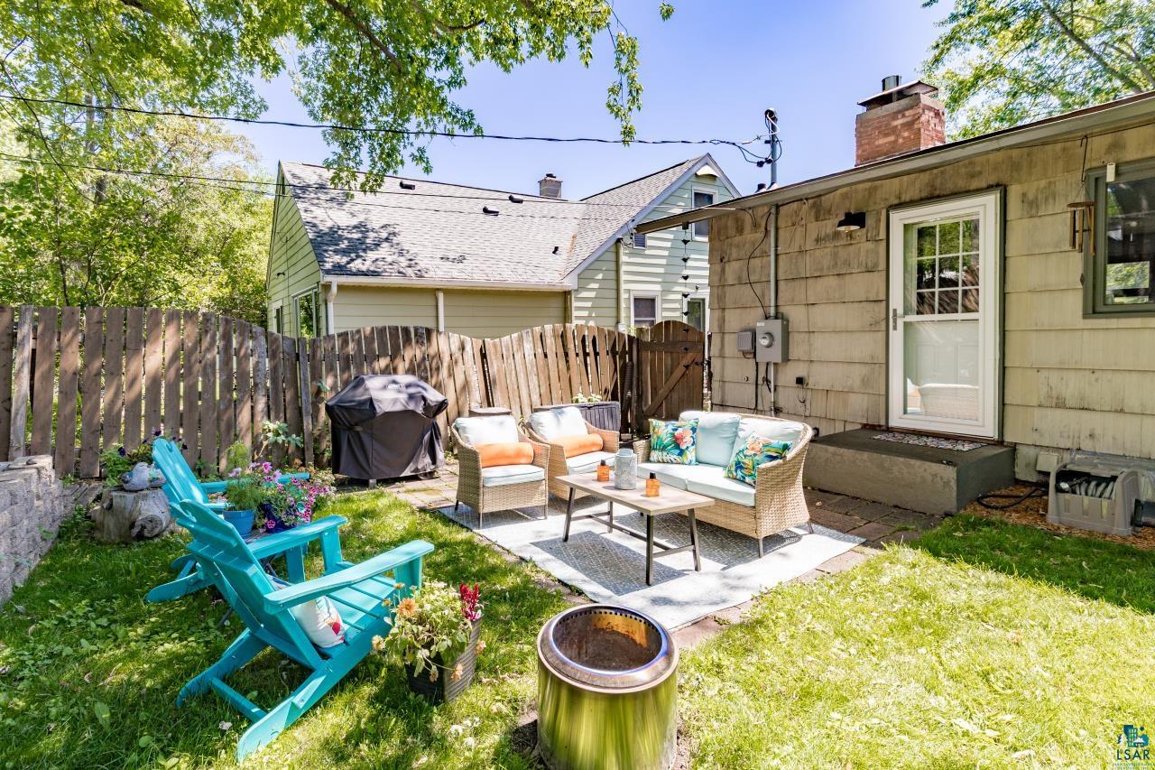 4119 Pitt Street Duluth, MN 55804 - Photo 27 of 50 Fenced backyard with a stone patio area and a grass lawn