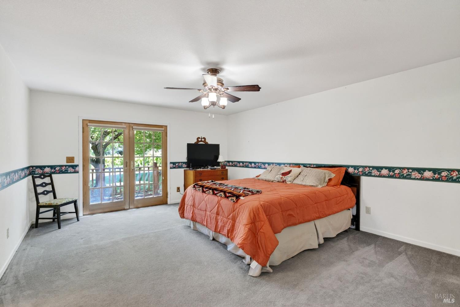 810 McNab Ranch Road Ukiah, CA 95482 - Photo 12 of 32 a bedroom with a bed and a chandelier