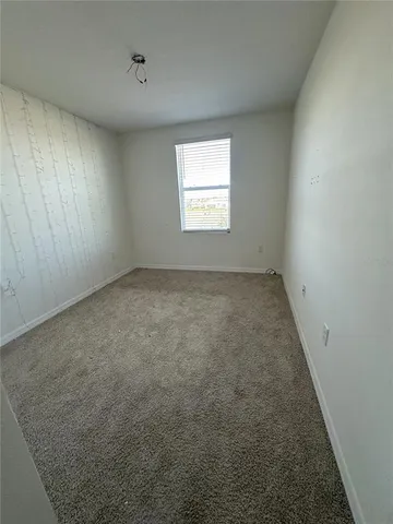an empty room with a empty space and windows