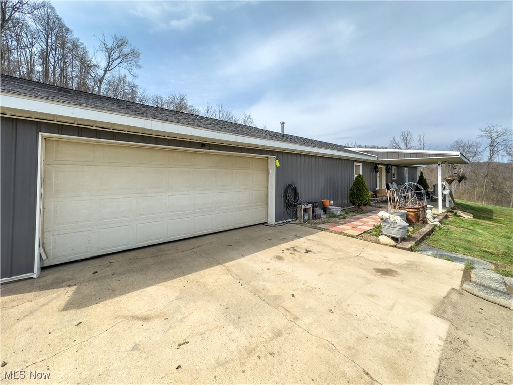 56567 Whiskey Run Road Quaker City, OH 43773 - Photo 11 of 43 View of front of home featuring a garage and concrete driveway