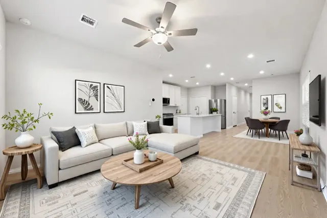 a living room with furniture kitchen view and a table