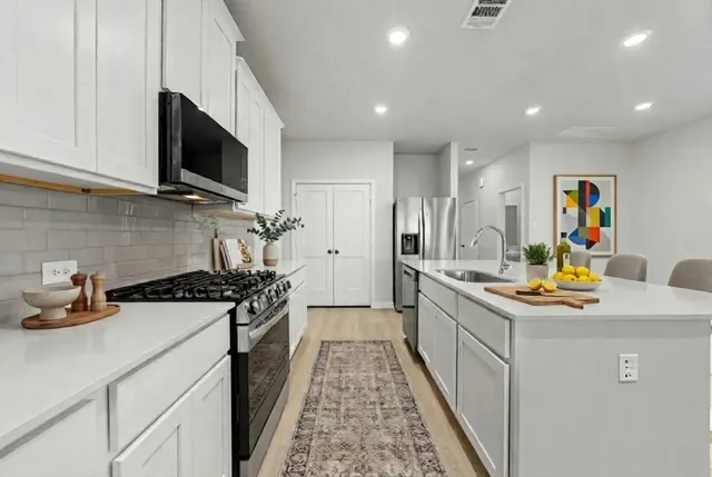 a kitchen with a stove and a sink