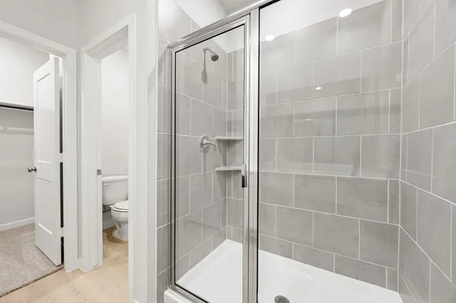 a bathroom with a shower and a glass door