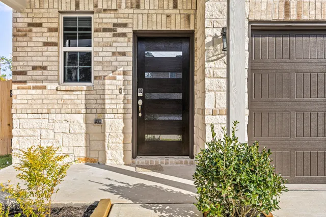 a couple of potted plants in front of door
