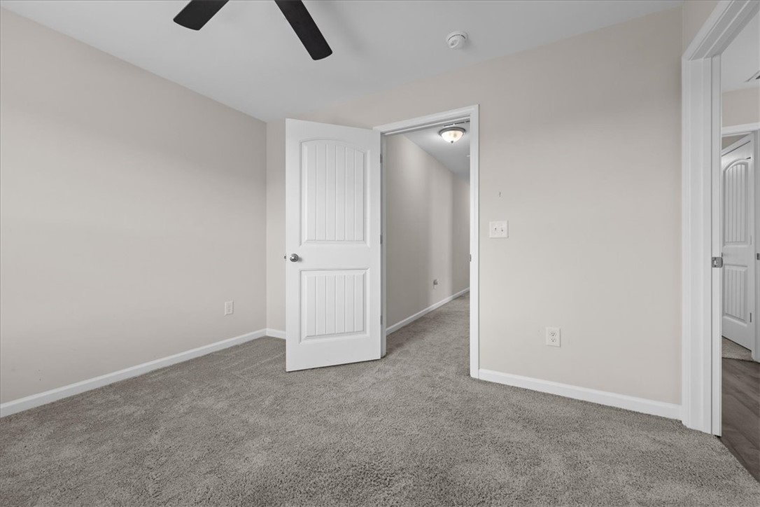 115 Adger Road Pendleton, SC 29670 - Photo 27 of 36 A well-lit bedroom with neutral walls and soft gray carpeting offers a blank canvas for personalization.
