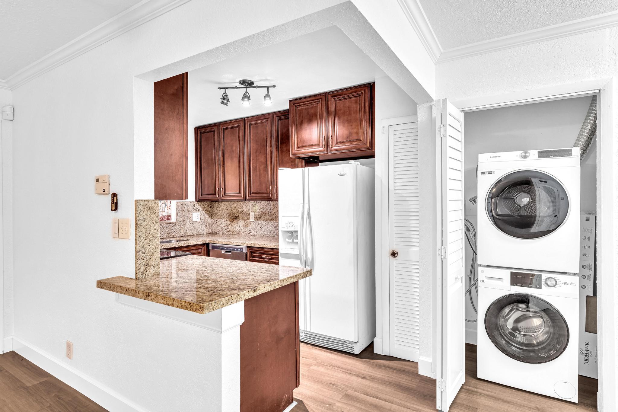 1291 Northwest 13th Street, Unit 445D Boca Raton, FL 33486 - Photo 19 of 50 a kitchen with a refrigerator sink and washer