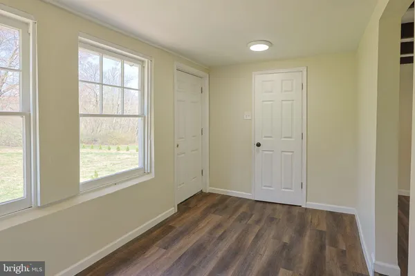 a view of entryway with wooden floor and window