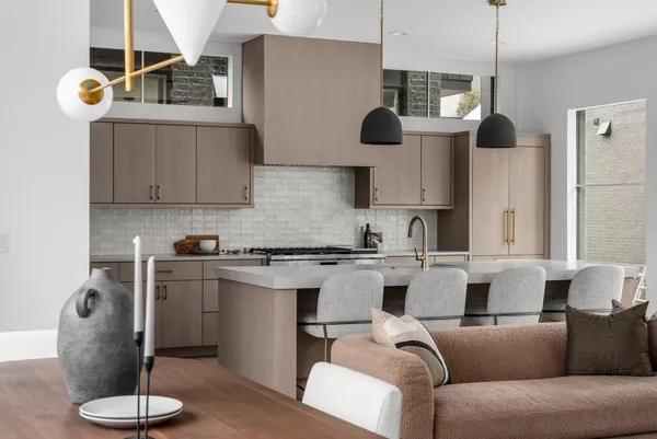 a kitchen with stainless steel appliances granite countertop a sink a stove and a wooden floors