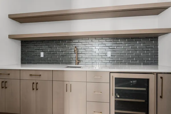 a sink with white cabinets