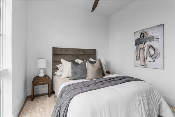 a bedroom with a bed and a painting on the wall