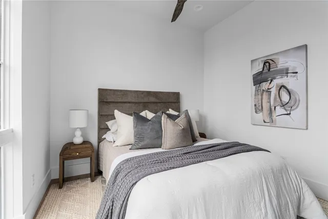 a bedroom with a bed and a painting on the wall