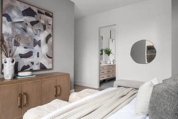 a bedroom with a bed and a mirror