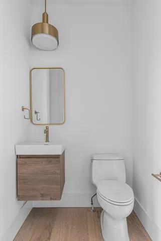 a bathroom with a toilet sink and mirror