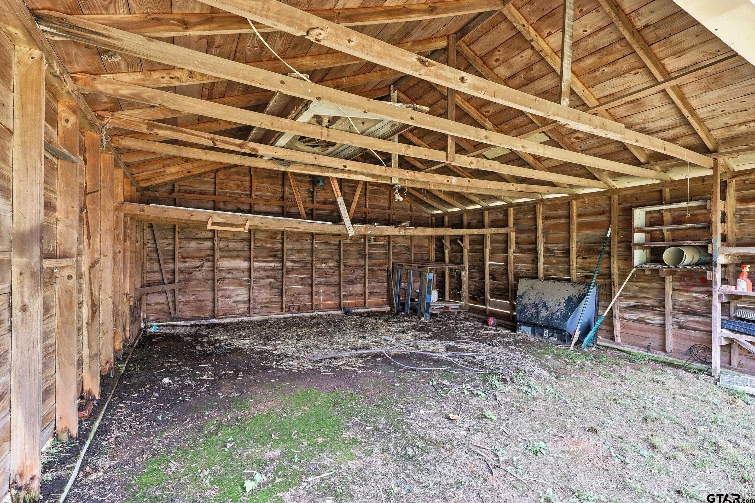405 Rusk Street Pittsburg, TX 75686 - Photo 27 of 33 a view of an empty room with wooden walls