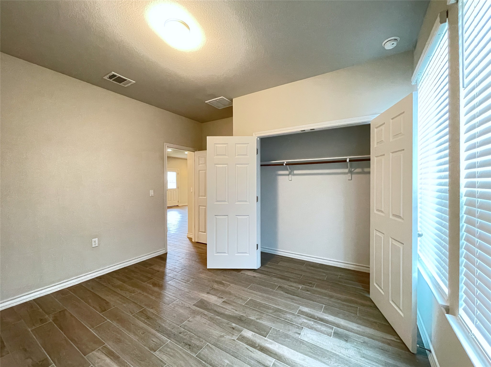 1602 Jacey Way Austin, TX 78725 - Photo 12 of 33 Room featuring wood-finish tile flooring and neutral wall tones