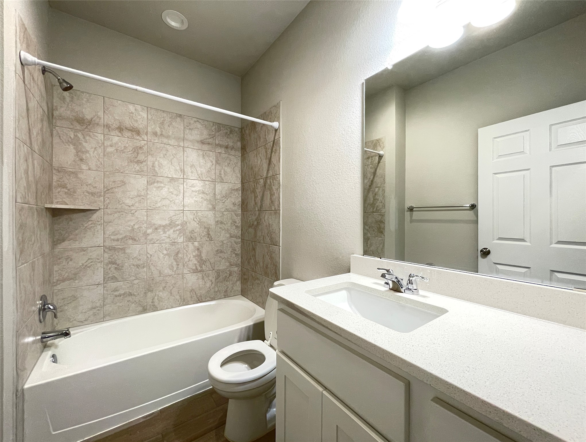 1602 Jacey Way Austin, TX 78725 - Photo 13 of 33 Bathroom featuring a vanity with a white countertop and integrated sink, chrome faucet, and expansive mirror