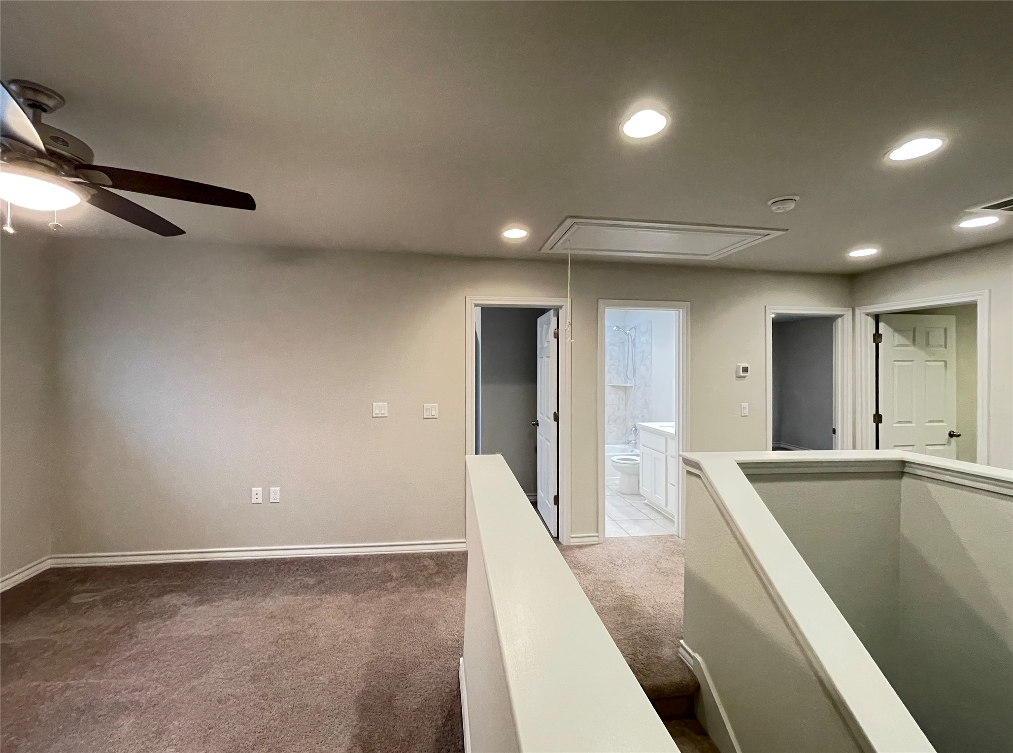 1602 Jacey Way Austin, TX 78725 - Photo 17 of 33 Carpeted landing with recessed lighting, ceiling fan, and multiple interior doors
