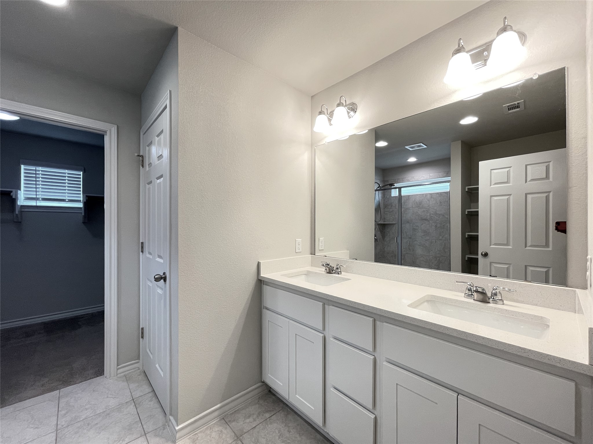 1602 Jacey Way Austin, TX 78725 - Photo 24 of 33 Dual vanity with white cabinetry and integrated sinks