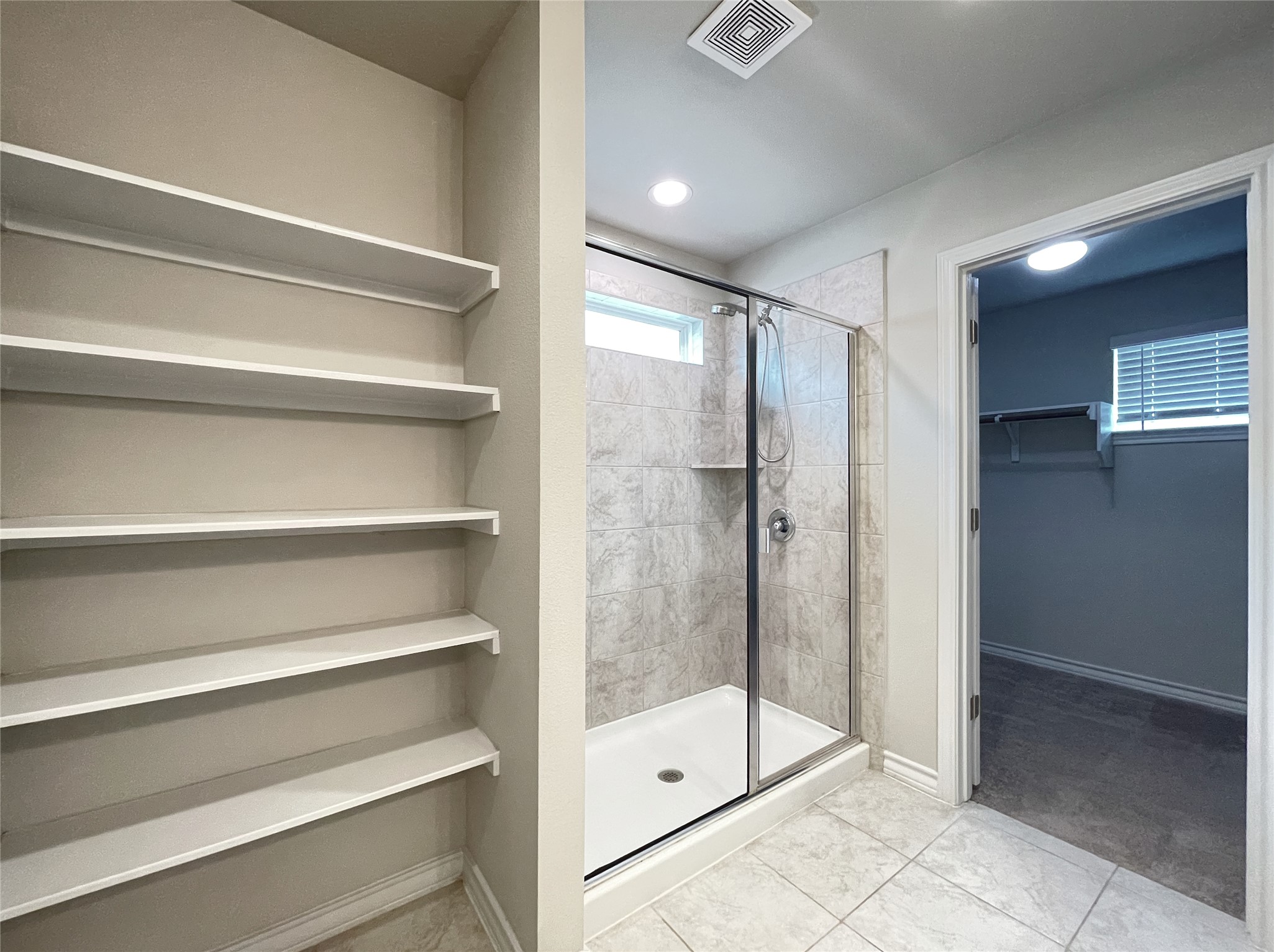 1602 Jacey Way Austin, TX 78725 - Photo 25 of 33 Walk-in shower with clear glass enclosure and tile surround