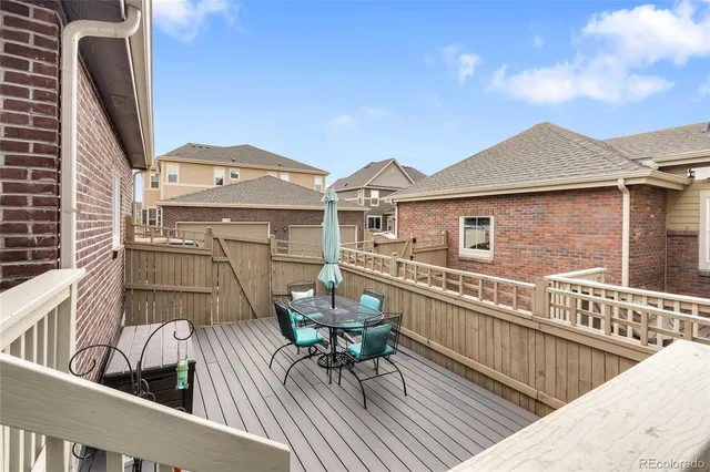 a view of a roof deck with furniture