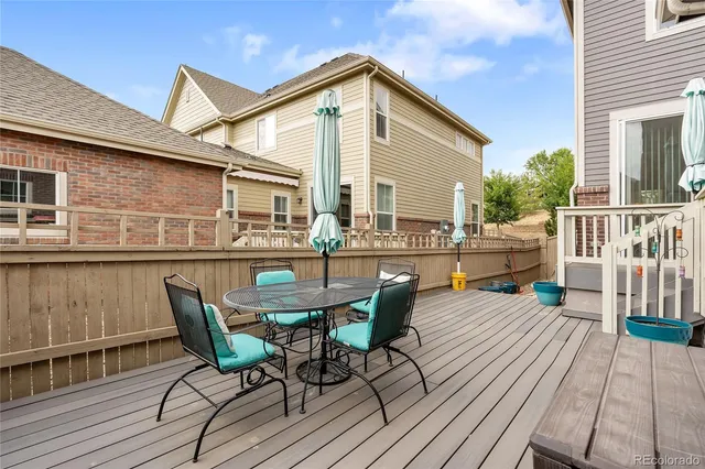 a view of a chairs and table on the wooden deck