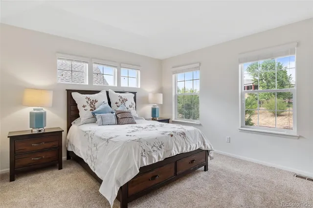 a bed sitting in a bedroom next to a window