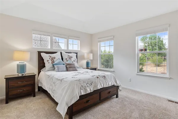 a bed sitting in a bedroom next to a window
