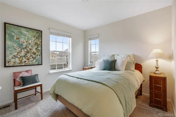 a spacious bedroom with a bed and a window