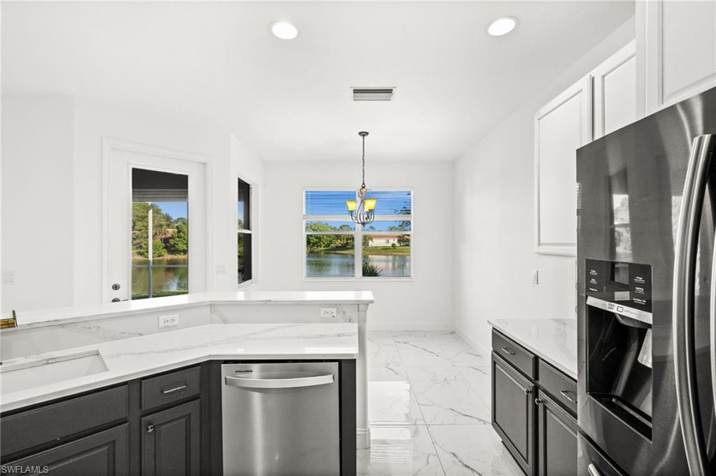 3972 Ruxton Road Naples, FL 34116 - Photo 6 of 41 a kitchen with stainless steel appliances granite countertop a refrigerator and a sink