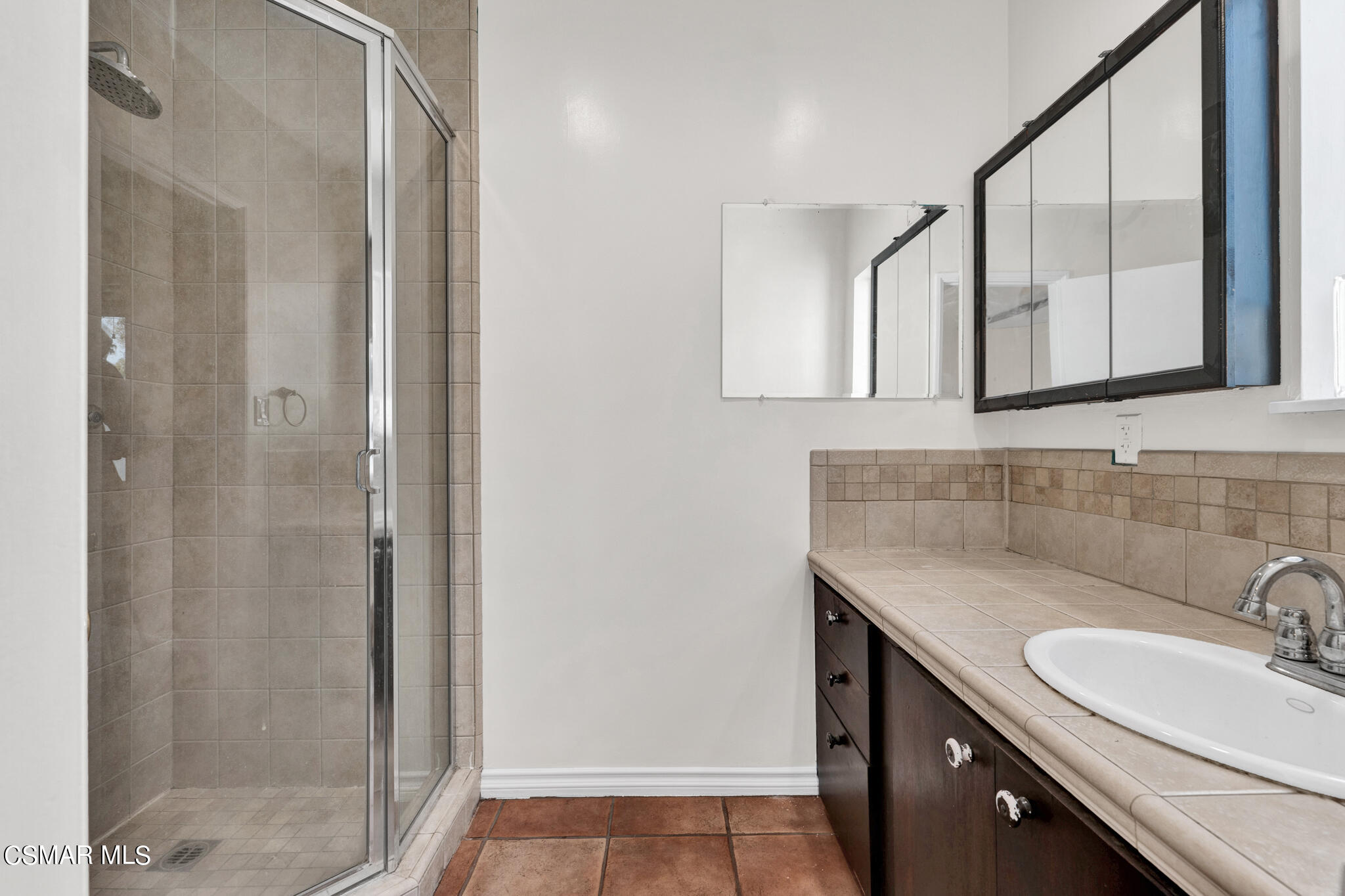 7348 Yolanda Avenue Reseda, CA 91335 - Photo 18 of 23 a bathroom with a granite countertop sink a mirror and a shower