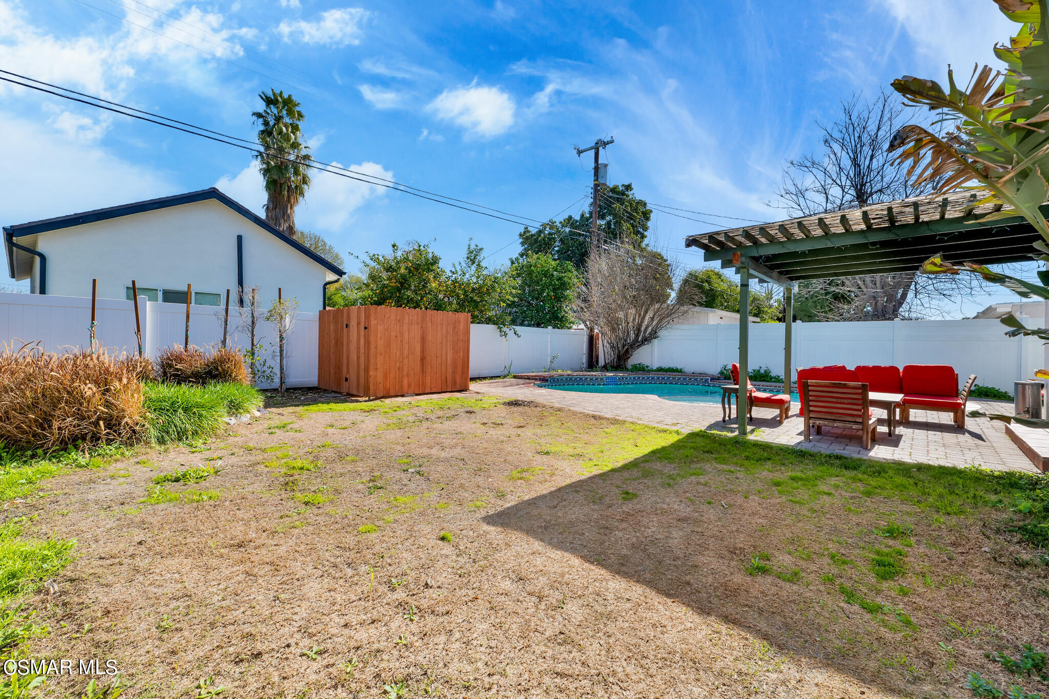 7348 Yolanda Avenue Reseda, CA 91335 - Photo 22 of 23 a view of a backyard with a table and chairs under an umbrella