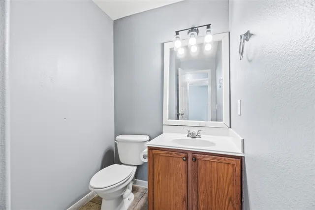 a bathroom with a toilet a sink and mirror