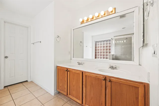 a bathroom with a sink a mirror and a shower