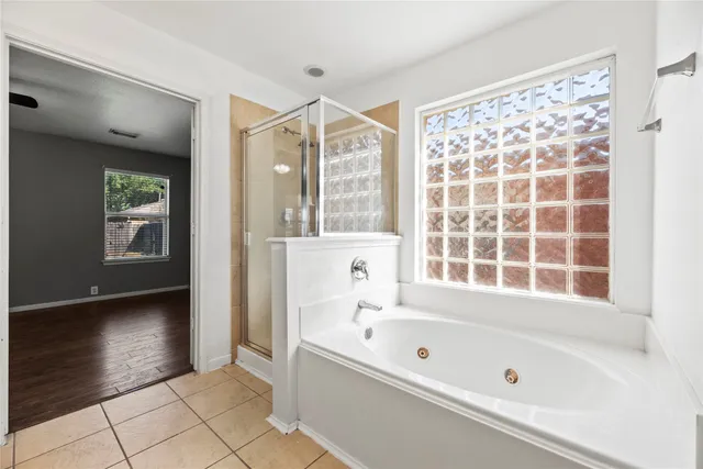 a bathroom with a bathtub and a shower