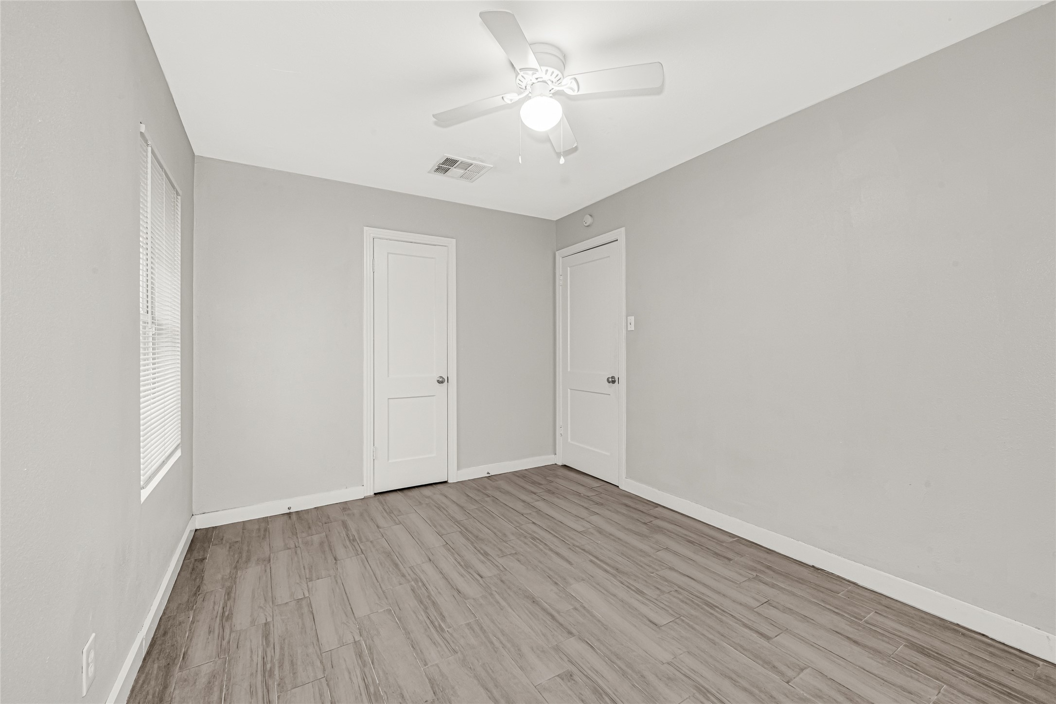 5009 Bataan Road Houston, TX 77033 - Photo 20 of 24 a view of an empty room with wooden floor