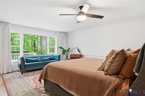 a bedroom with a bed and a chair