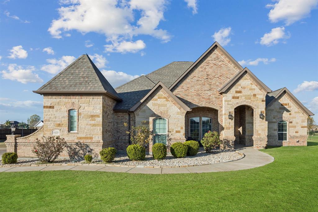 a front view of a house with a yard
