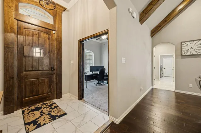 a walk in closet and wooden floor