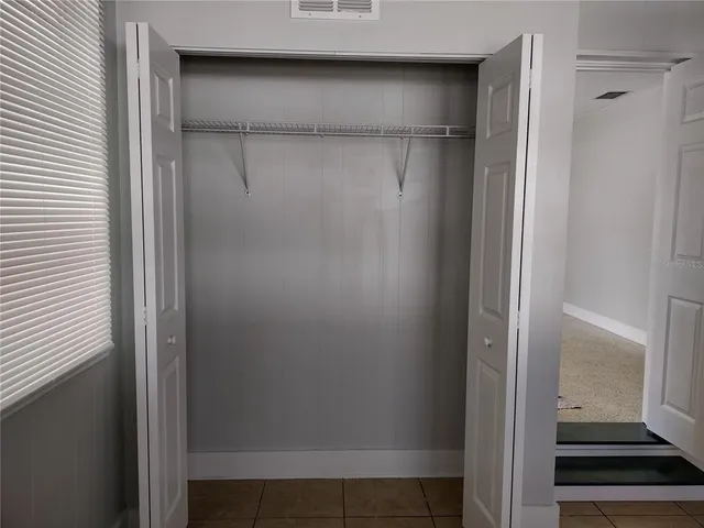 a kitchen with white cabinets and a sink