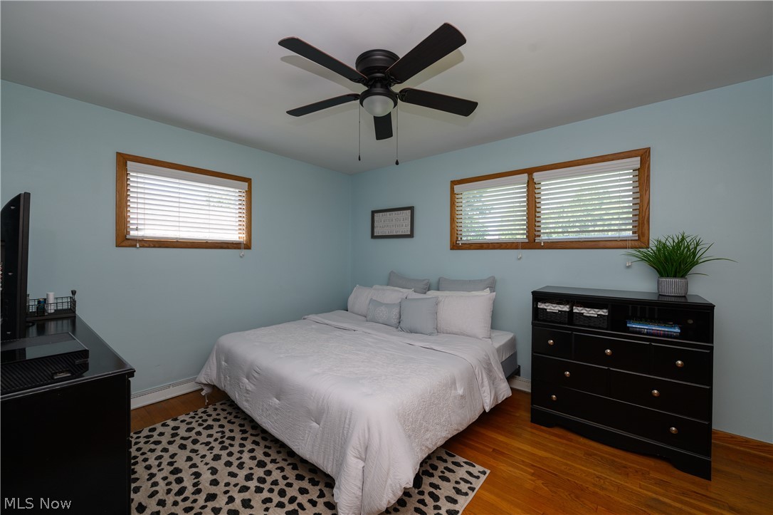 1243 Garman Road Akron, OH 44313 - Photo 19 of 21 Bedroom featuring ceiling fan, multiple windows, and light hardwood / wood-style flooring