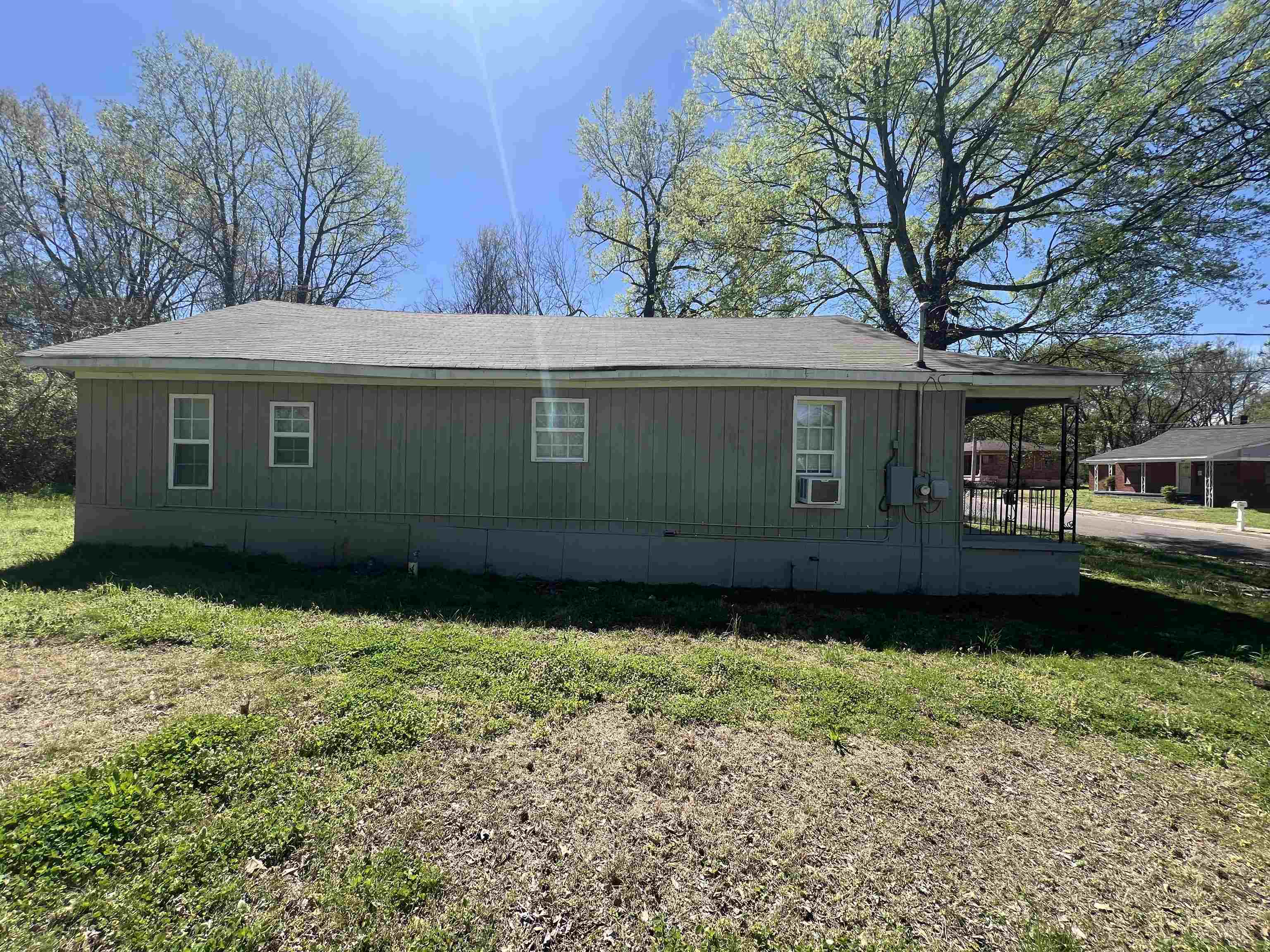 3044 Green Road Memphis, TN 38109 - Photo 11 of 13 View of side of home with a lawn and a shingled roof