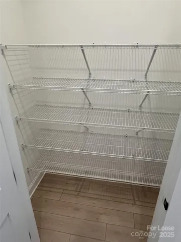 a kitchen with stainless steel appliances granite countertop a sink a stove and a wooden floors