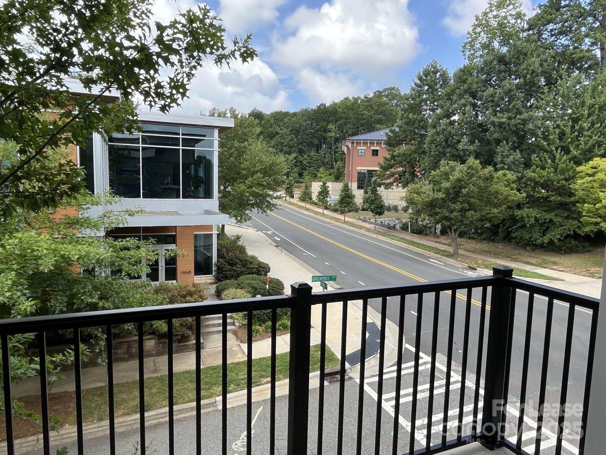 19546 Greentree Way, Unit 201 Cornelius, NC 28031 - Photo 17 of 31 a balcony view with a garden view