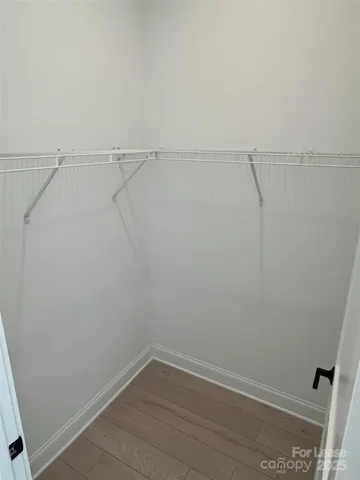 a spacious bathroom with a toilet sink and mirror