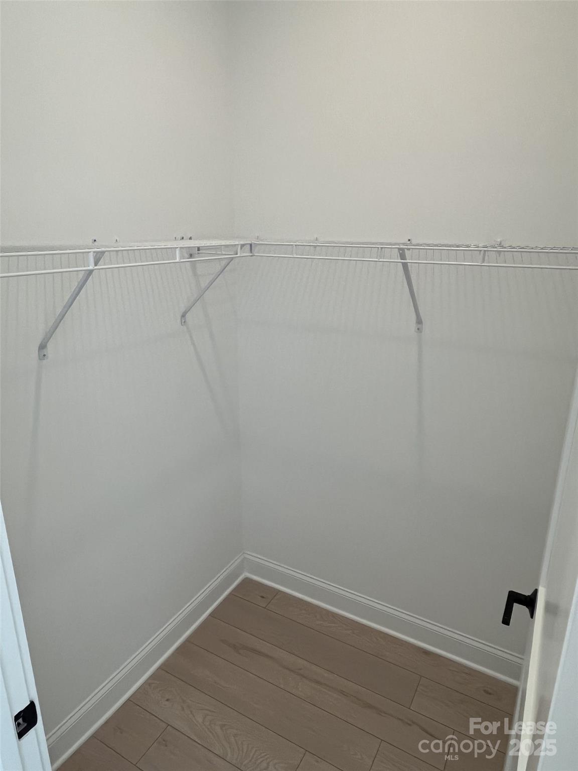 19546 Greentree Way, Unit 201 Cornelius, NC 28031 - Photo 25 of 31 a view of a room with racks on the wall