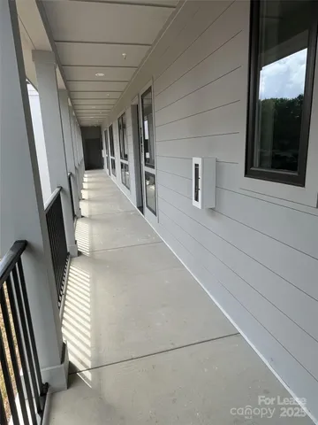 a view of a hallway with entryway and stairs