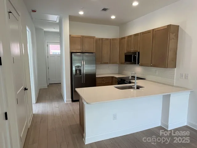 a kitchen with stainless steel appliances a refrigerator and a stove
