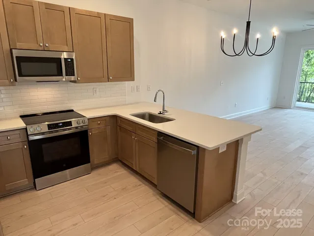 a kitchen with a sink and a stove top oven